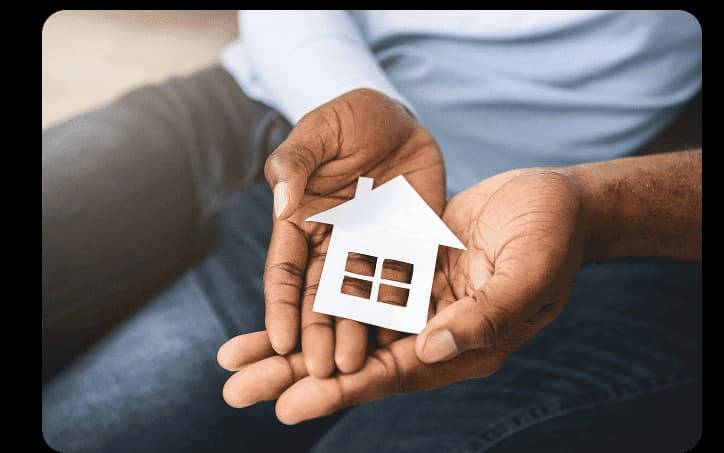 Couple holding a house icon